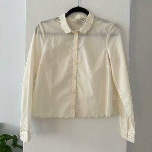 Ivory collared button-down shirt with scalloped detailing.